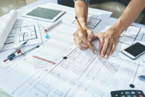 Close-up image of engineerr drawing blueprint